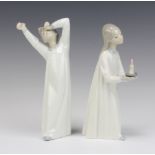 Two Lladro figures of a girl and boy in night dresses 21cm The candle is stuck
