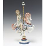 A Lladro figure of a girl on a carousel horse no.1469 40cm There are minor chips to the flowers