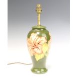 A Moorcroft style baluster table lamp decorated hibiscus on a green ground 28cm This item is not