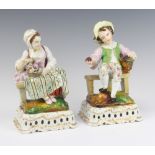 A pair of 19th Century German porcelain figures of a seated lady and gentleman raised on pierced