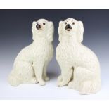A large pair of Victorian Staffordshire fireside spaniels with separated front legs and gilt