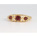 An 18ct yellow gold garnet and diamond ring 4.4 grams, size L 1/2