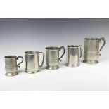 A victorian pewter quart measure and 4 pewter tankards