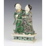 A 19th Century Chinese famille verte group of 2 standing gentleman, 1 holding a lidded box the other