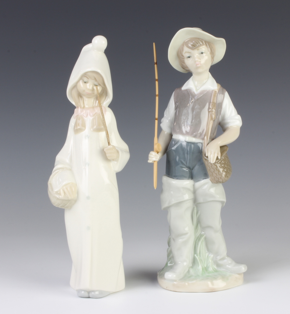 A Lladro figure of a girl in a hooded coat 22cm and a ditto of a boy fisherman 4809 23cm The