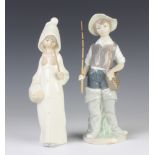 A Lladro figure of a girl in a hooded coat 22cm and a ditto of a boy fisherman 4809 23cm The