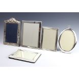 A modern repousse silver arch shaped photograph frame 25cm, 4 silver plated frames
