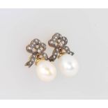 A pair of silver gilt Edwardian style cultured pearl and diamond drop earrings with tied bow tops