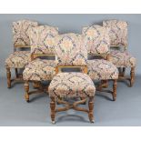 A set of 5 Edwardian oak framed dining chairs with upholstered seats and backs, raised on cup and