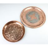 A circular Newlyn style planished copper dish decorated fish 28cm diam. together with a circular