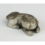 A Chinese carved hardstone figure of a reclining shi shi 5cm