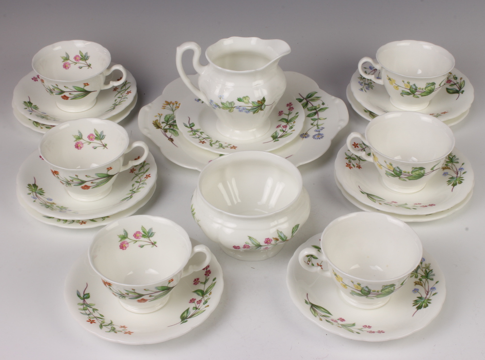 A Minton part tea set with multi floral decoration comprising 6 tea cups, 6 saucers, 5 side