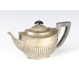 A Victorian silver demi-fluted bachelor's teapot with ebony mounts, gross 319 grams The hallmarks