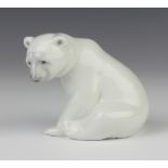 A Lladro figure of a seated polar bear cub 8cm