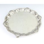 A Georgian style silver salver with shell rim on scroll feet, London 1915, 28cm, 525 grams