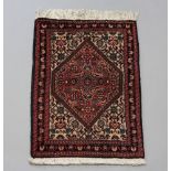 A blue and red ground Persian slip rug with diamond medallion to the centre within a 3 row border