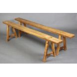 A pair of 19th Century cherry trestle benches, raised on out swept supports 50cm h x 200cm l x