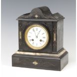 A Victorian French 8 day striking mantel clock with enamelled dial contained in a black and white