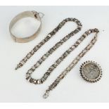 A Victorian silver chain, a brooch and a bangle, 84 grams