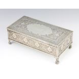 A Persian silver rectangular cigarette box decorated with exotic birds amongst flowers with vacant