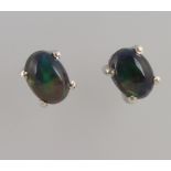 A pair of silver black opal ear studs