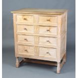 A Heals White Spot 17th Century style carved and limed oak chest of 2 short and 3 long drawers