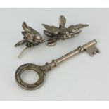 A silver presentation key together with a group of 2 silver birds 118 grams