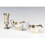 A silver waisted cup Birmingham 1972, 2 cream jugs, 227 grams