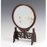 A Chinese silk work circular embroidery of an exotic bird contained in a circular hardwood frame and