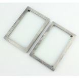 A pair of engine turned silver rectangular photograph frames 15cm x 10cm