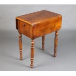 A Victorian walnut drop flap work table with quarter veneered top fitted 2 long drawers and cupboard