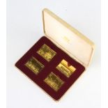 Four silver gilt stamps, 107 grams, cased