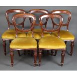 A set of 5 Victorian mahogany balloon back dining chairs with shaped mid rails and over stuffed