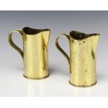 A pair of American WWI trench art jugs formed from shell cases, 1 marked 75DEC H2601 15 USA, the