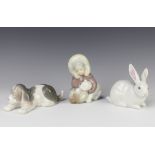 A Lladro figure of a rabbit 5905 12cm, a ditto of a sleeping hound 17cm and an a eskimo boy with