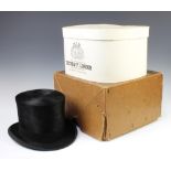 A Tressie and Co of London gentleman's black silk top hat, size 7 1/4 There is some moth damage to