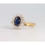 An 18ct yellow gold oval sapphire and diamond cluster ring, 3 grams, size K 1/2