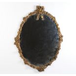 An oval plate mirror contained in a decorative gilt frame 89cm h x 69cm 9 candle sconces are missing