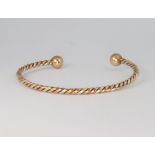 A 9ct yellow gold rope twist torque bangle 12.3 grams