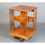 An Edwardian square walnut 2 tier revolving bookcase with quarter veneered top 79cm h x 49cm w x