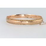 A 9ct yellow gold engraved bangle 8.6 grams