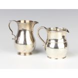 An Edwardian Georgian style silver cream jug, London 1902, a baluster ditto 246 grams