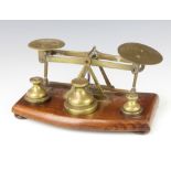 T J and J Smith London, a pair of Victorian brass letter scales raised on a wooden stand complete