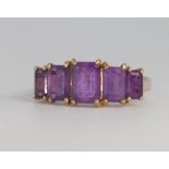 A 9ct yellow gold baguette cut amethyst ring size P 1/2
