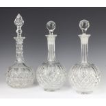 A pair of mallet shaped decanters and stoppers 28cm and a ditto 32cm