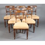A set of 6 Victorian mahogany balloon back dining chairs with carved mid rails and overstuffed seats