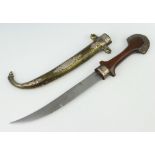 A Jambuka style dagger with 22cm blade contained in a gilt metal and "silver" scabbard with wooden