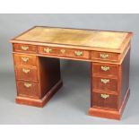 A mahogany kneehole pedestal desk with green inset leather writing surface, above 1 long and 8 short