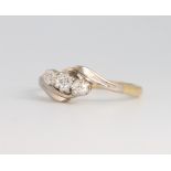 An 18ct yellow gold 3 stone diamond crossover ring 2.4 grams, size J 1/2