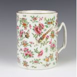 An 18th Century famille rose mug decorated with birds amongst flowers with an entwined handle 15cm